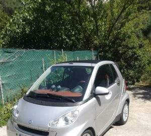 car rentals in Rhodes are a great way to save money as there is no uber- silver car, trees, green fence