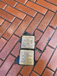3 days in Amsterdam Itinerary, Holocaust and Jewish Tour- brown cobbles, gold plates in ground with Jewish Holocaust victims names on, Netherlands