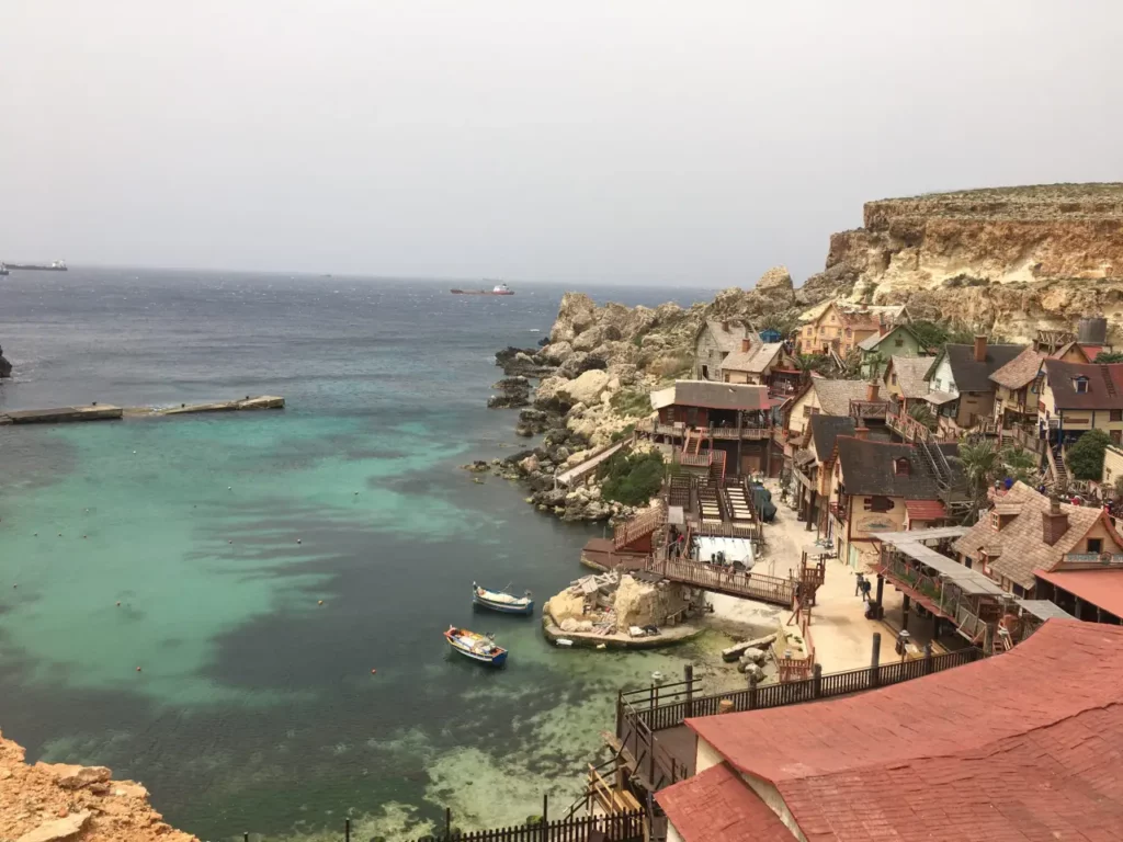 Is Popeye Village Worth Visiting? blue water, red roofs, bay, Malta