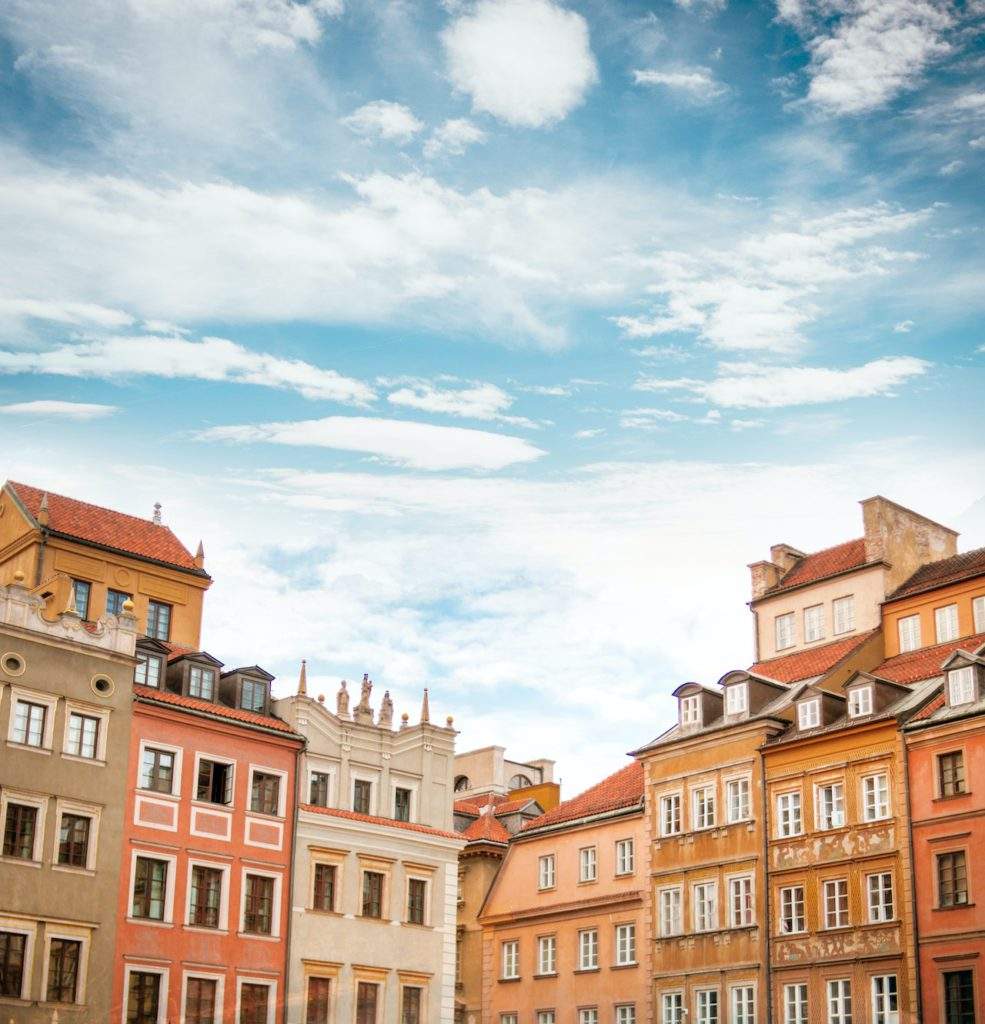 Poland Holocaust Tours, Warsaw Jewish Ghetto- blue skies, clouds, tall polish buildings, Warsaw