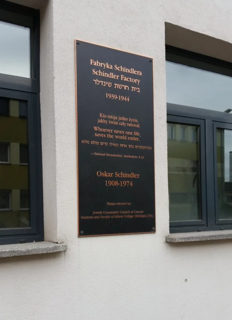 Schindlers Factory, Poland Holocaust tours in Europe- white building, dark sign with information about O. Schindler, Krakow in Poland