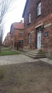 Auschwitz luxury tour from Krakow- tall brick buildings, steps, paved road, Auschwitz