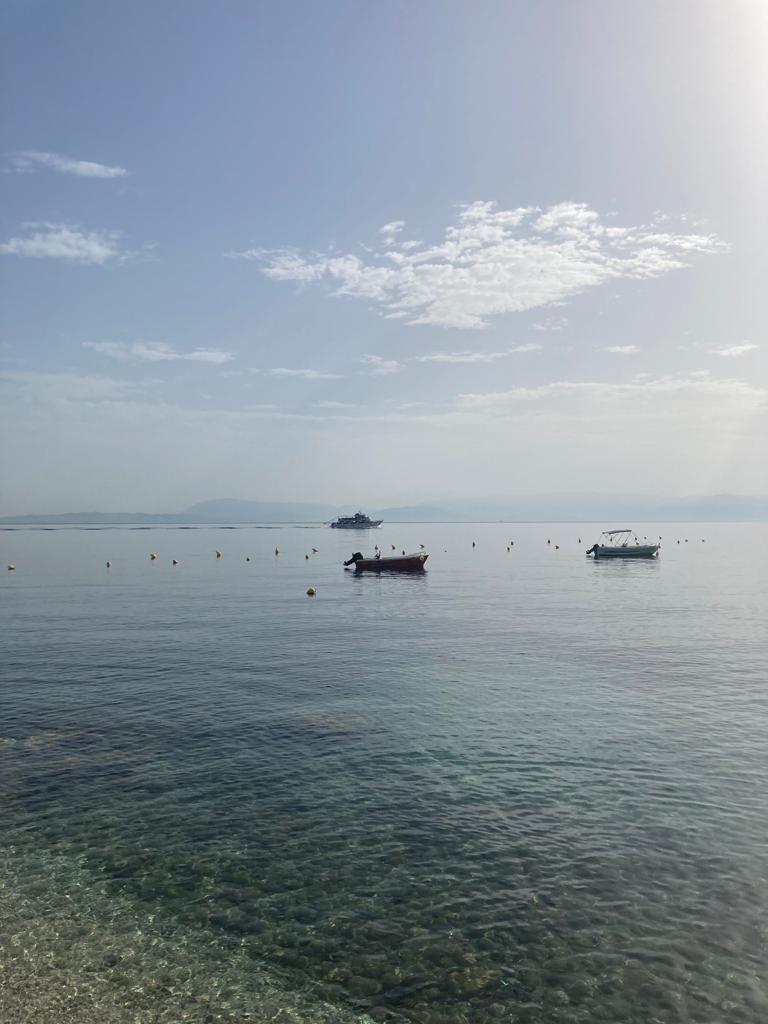 Corfu Private Yacht Cruise- crystal clear waters, small boats, blue sky, Corfu