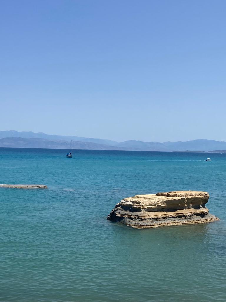 Private Sailing Yacht For Large Groups Corfu- blue water, blue sky, sandy rocks, Corfu