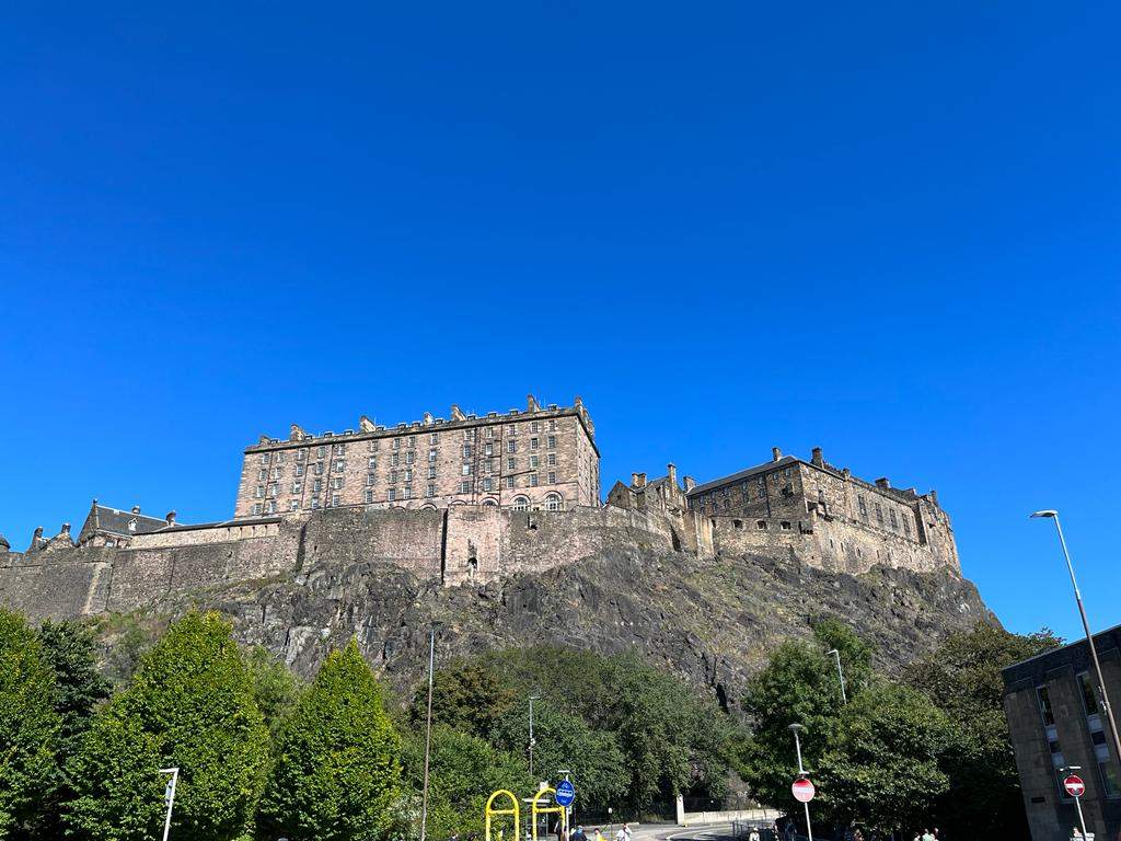 Edinburgh Ghost Tours are the best in Europe and worth booking all year round- Edinburgh castle, trees, blue sky, Scotland