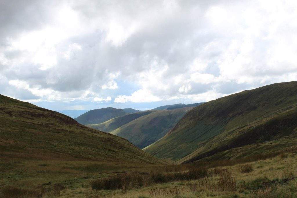 the best trips to Wales from London to Visit Snowdonia National Park- sky, clouds, mountains, green grass, Wales