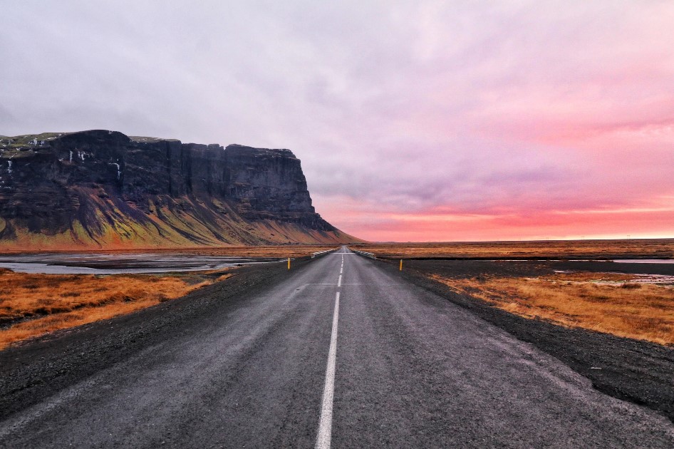 Hella in Iceland is a popular stop when driving the ring road towards Vik- long road through sunset sky and summer landscapes in Iceland