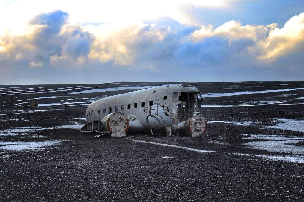 Iceland plane crash- black sand beach, plane remains, bright sky, Southern Iceland