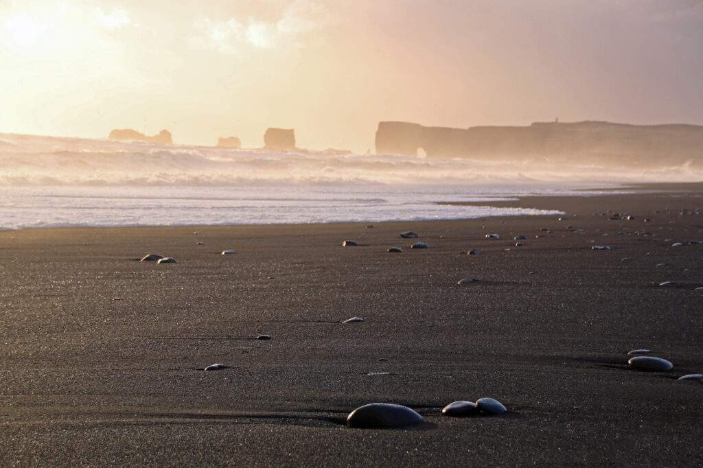 Reynisfjara black sand beach, top stops between reykjavik to vik- sunset, black sand beach with big pebbles, southern Iceland