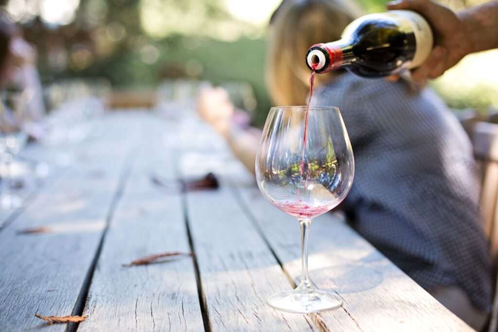 best walking food and history tours in Malta- local Malta red wine, glass, table outside, group tour