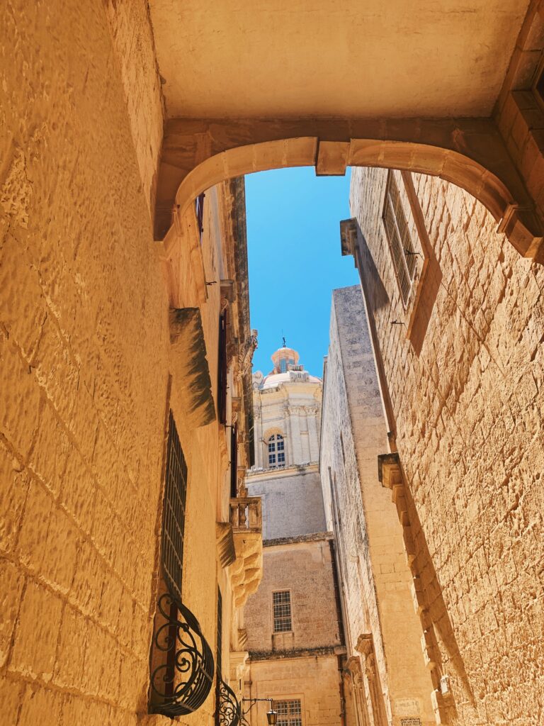 best walking tour Malta, Mdina will take your through the sand coloured cobbled alleys that the buildings tower above