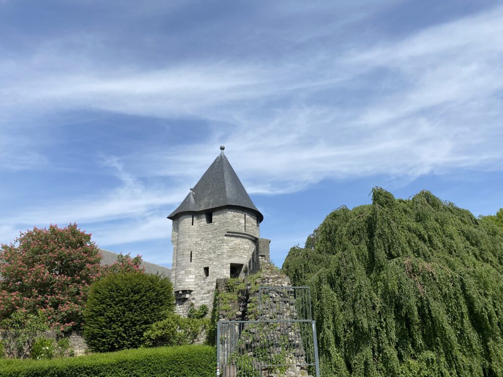 Maastricht is a great city to visit as it has lots of historic buildings. The Hellport stands out from the green trees and cobbled steps underneath the blue summer skies in Limburg, Netherlands