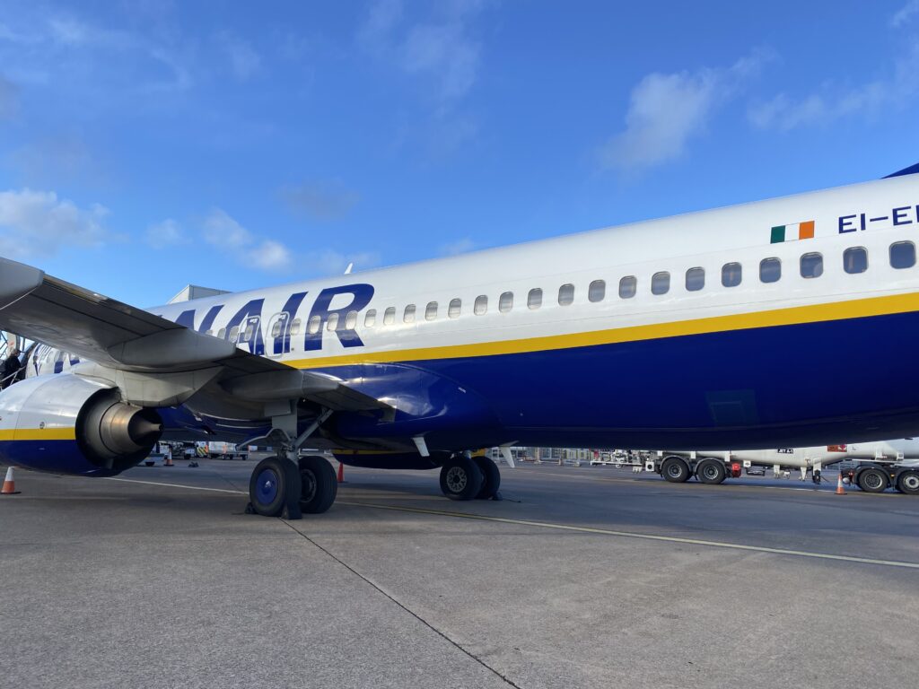Ryanair plane sat on the airport tarmac on a clear day in the UK